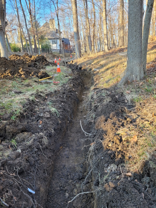 Ensuring the French drain follows the grade for efficient drainage